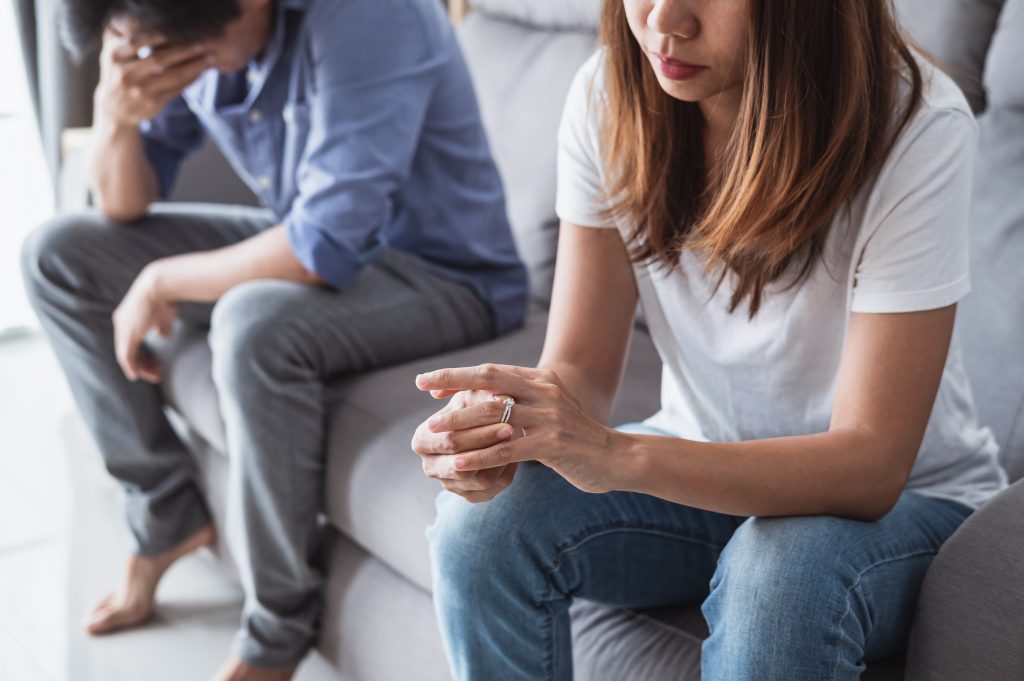 Frustrated sad wife taking off the wedding ring, Young couple breaking up divorce concept